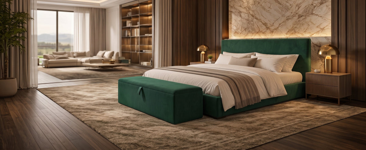 Emerald green velvet ottoman storage box at the foot of a matching upholstered bed in a modern luxury bedroom.