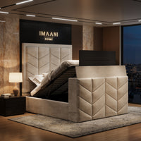 Aura chevron TV ottoman bed with raised television and lift-up mattress platform revealing under-bed storage.