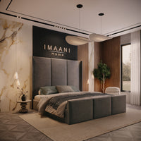 Birmingham wingback high headboard bed with broad upholstered panels and matching three-panel footboard, shown from a three-quarter view.