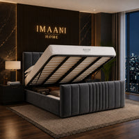 Halston dark grey ottoman storage bed shown open, with a lift-up mattress base, high vertical-panel headboard and matching channelled footboard.