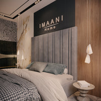 Close side view of the Hope high headboard bed in soft grey upholstery, showing broad vertical padded sections separated by slim recessed channels.